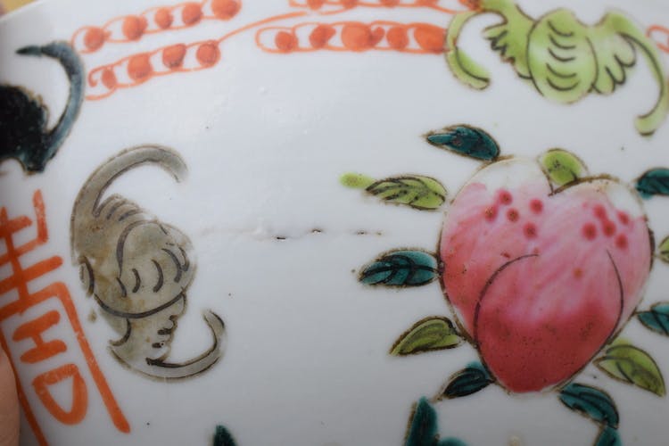 A large antique chinese bowl decorated with peach & bats Late Qing Dynasty