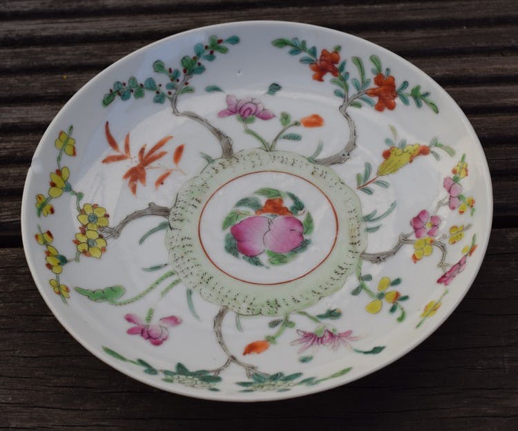 Antique chinese famille rose plate decorated with flowers, peach and bat