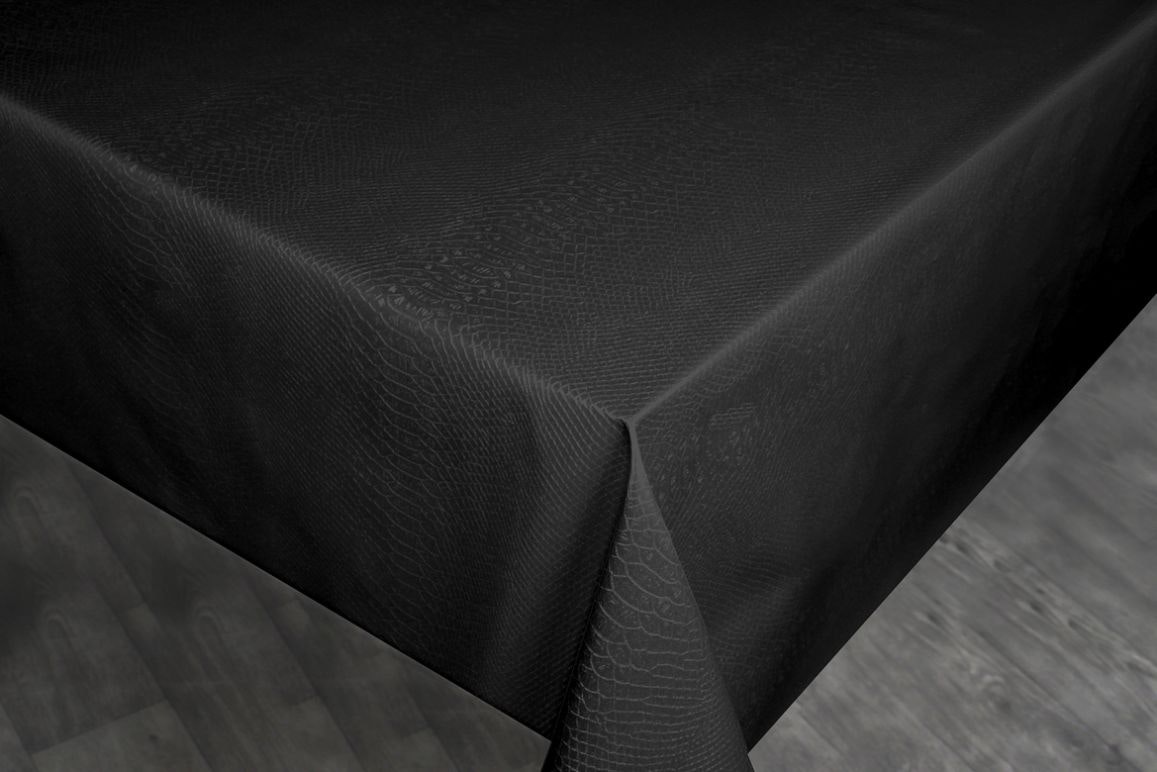 Black en svart vaxduk på metervara med ett präglat krokodilskinnsmönster i bredd 140 cm.