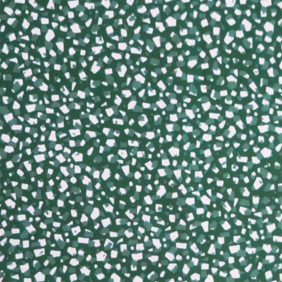 Assar en grön textilvaxduk med ett terazzomönster i vitt och grönt på metervara i bredd 138 cm från Redlunds textil