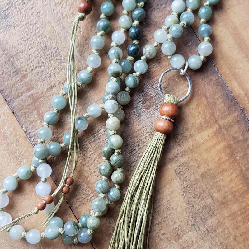 Mala halsband med fina pärlor av grön jaspis och handgjord tofs av svensk lintråd i mjuk ljusgrön nyans.