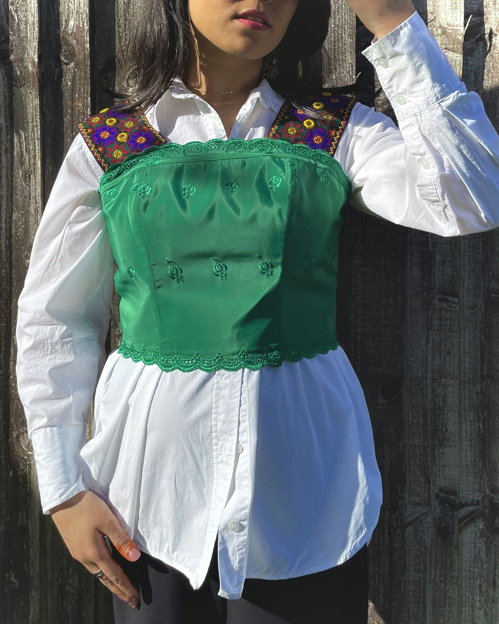 Handmade corset top featuring gorgeous traditional hand embroidered shoulder strap with fully lined cotton fabric with adjustable lace-up back. The name Benafshe is inspired by the spring flower.