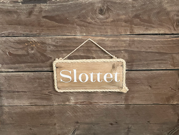 Slottet - skylt av drivved