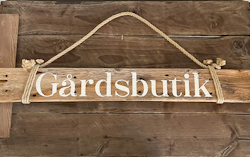 Gårdsbutik - skylt av drivved