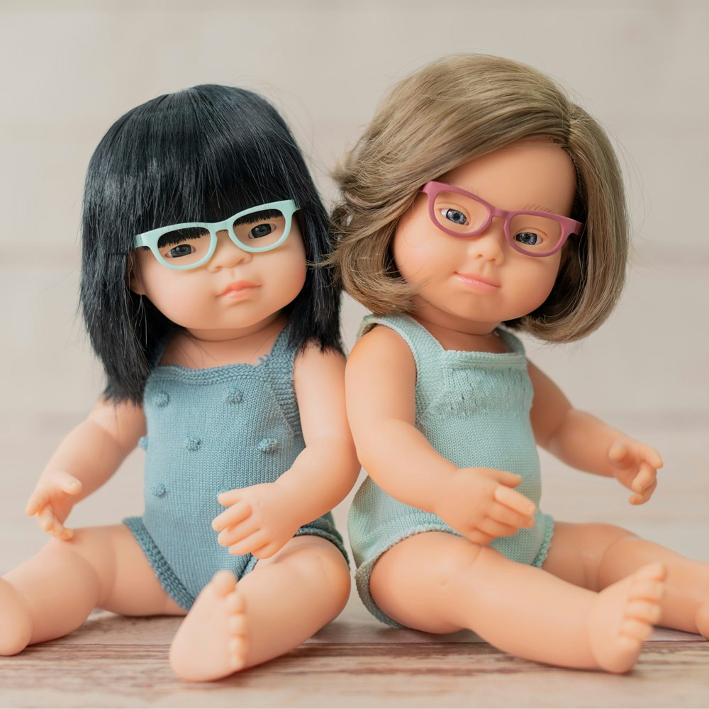 Baby doll caucasian girl with Down syndrome and glasses with turquoise rompers 38 cm