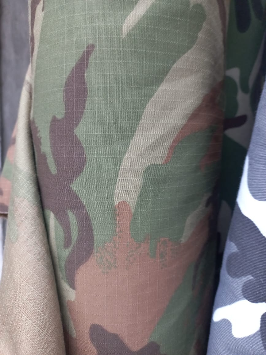 Camo canvas tote bag with leather straps.