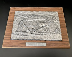 Wall plaque, pewter, Man interprets behind horse, signed