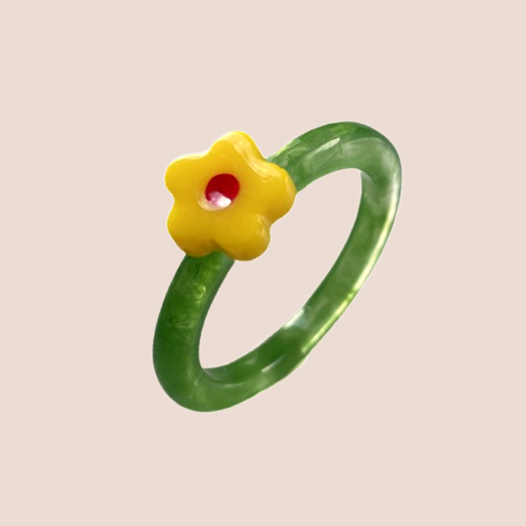 Tunn ring med en gul blomma