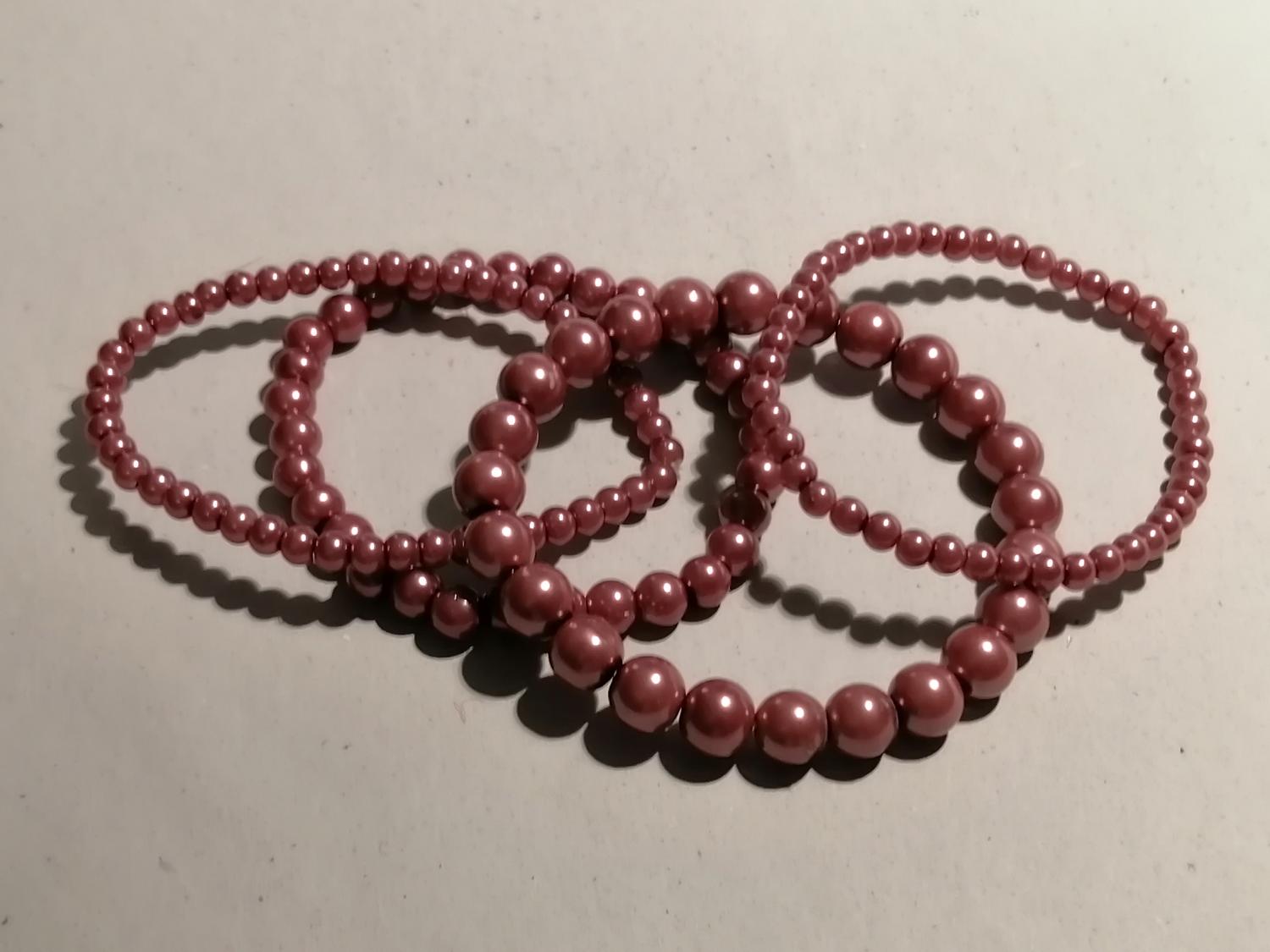Second hand bijouteri smycke armband 4 st rosa-lila pärlor stora och små