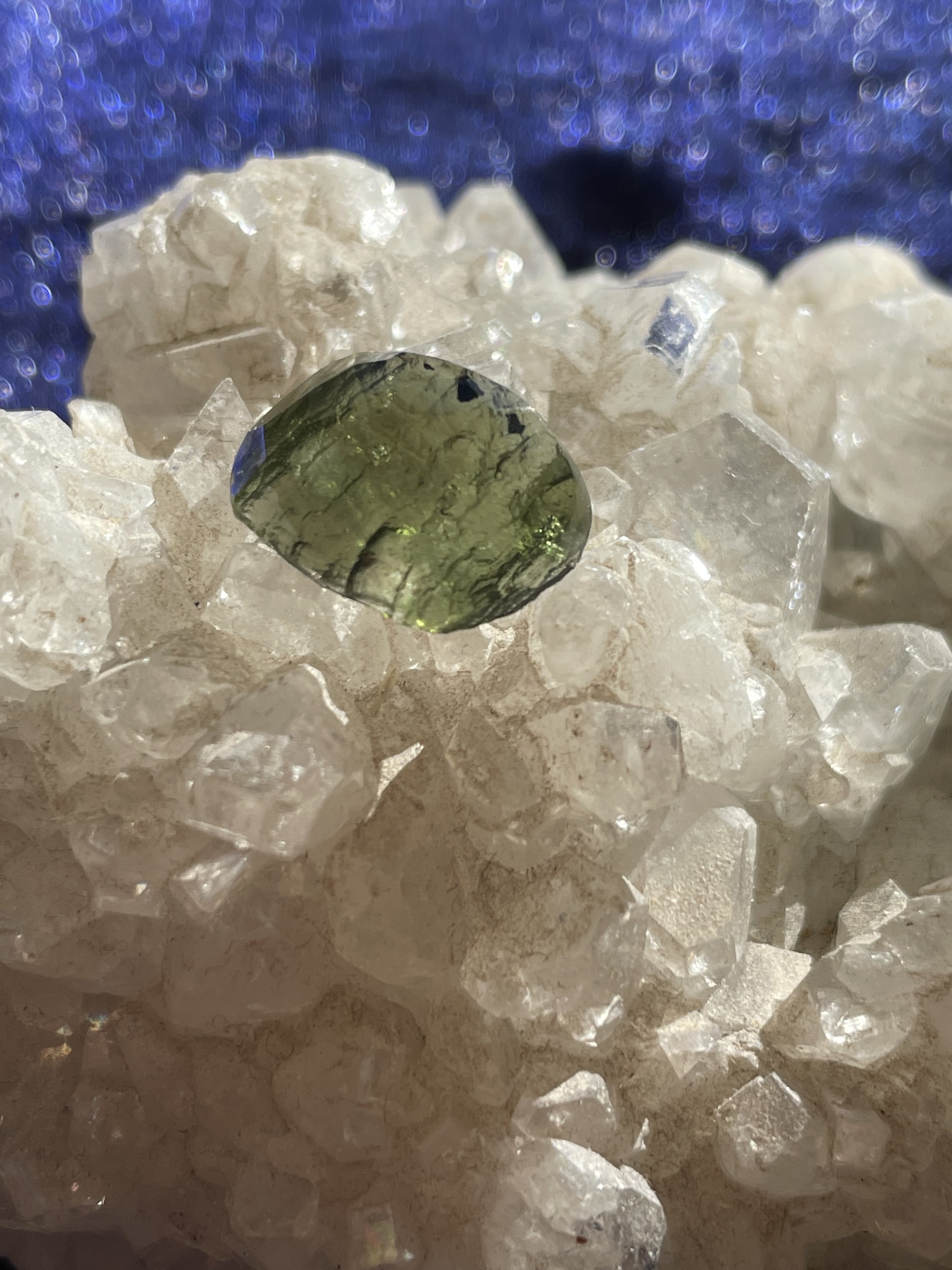 bilden visar två Moldaviter på ett bergskristallkluster