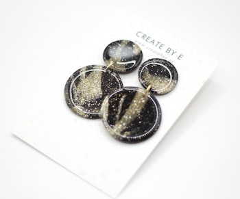 Glossy circle (svart/guldglitter/gloss)