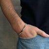 Stålarmband kombinerat med bruna ädelstenar för män på arm