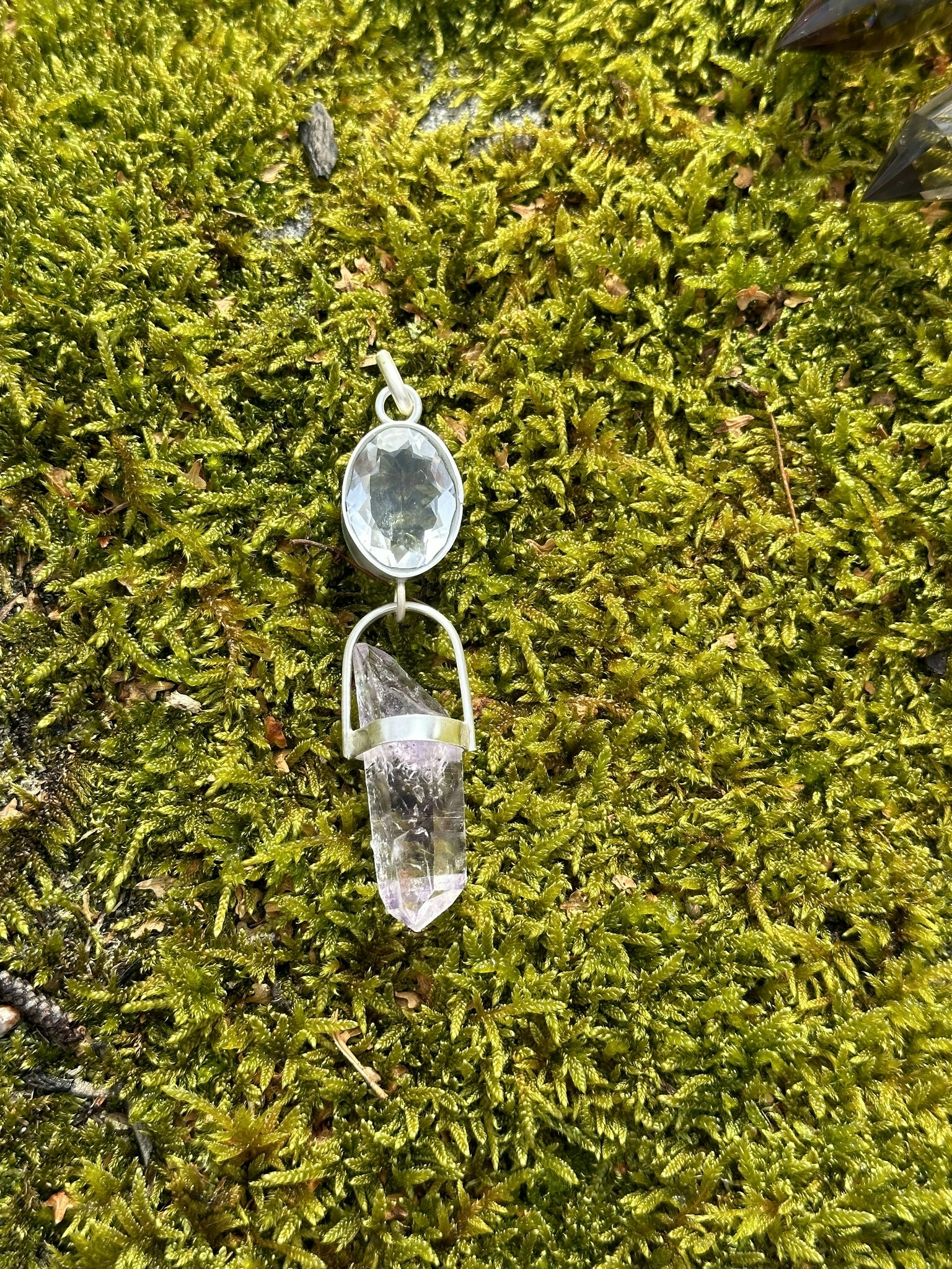 Faceted quartz crystal with Enhydro Brandenberg amethyst