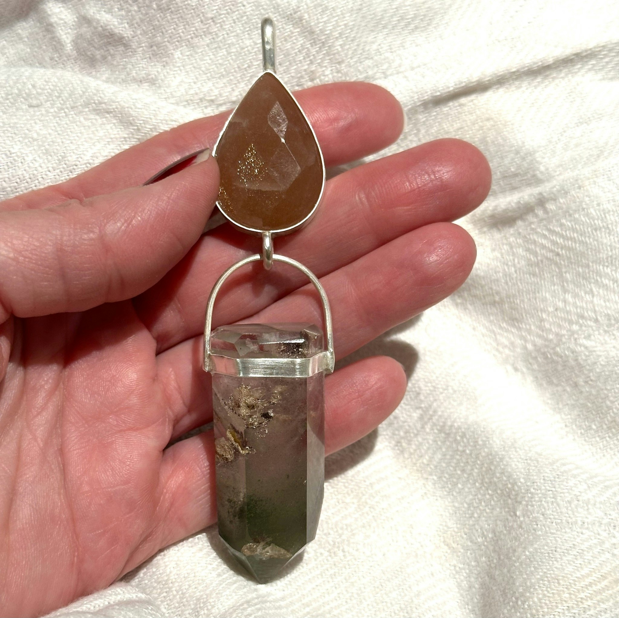 Faceted natural moonstone with lodolite full of phantoms