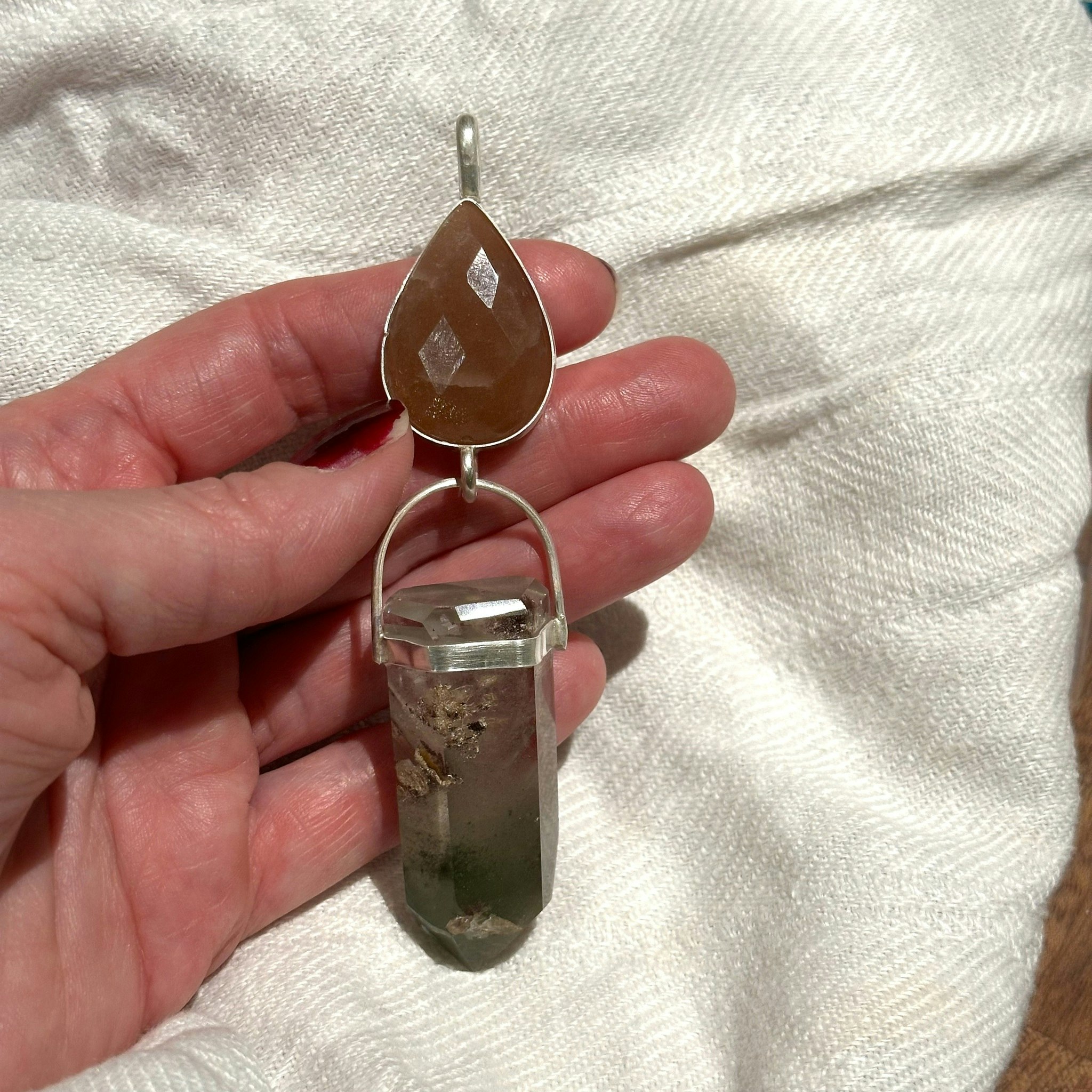 Faceted natural moonstone with lodolite full of phantoms