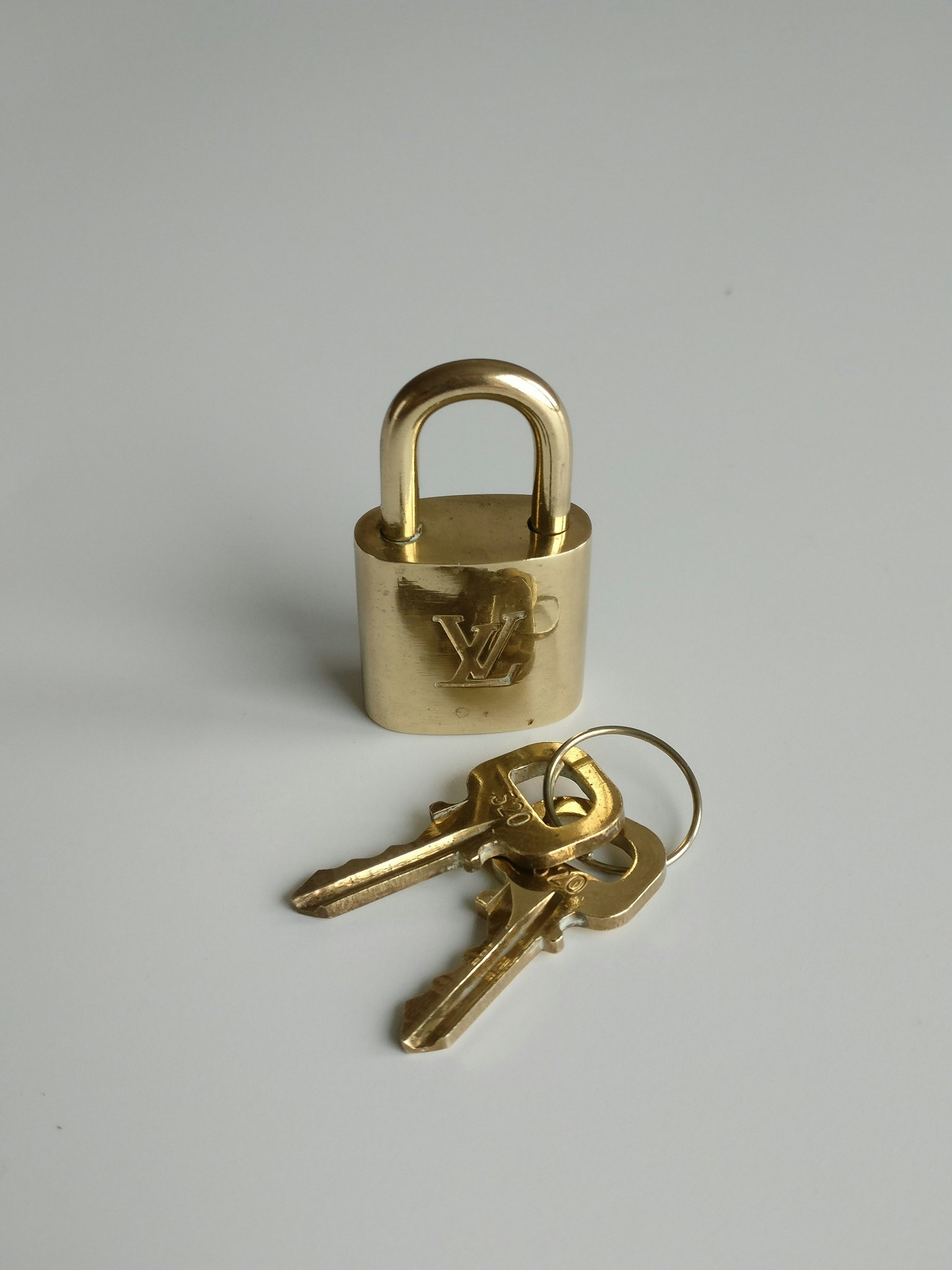 Lot - A Louis Vuitton Padlock w/ 2 Keys