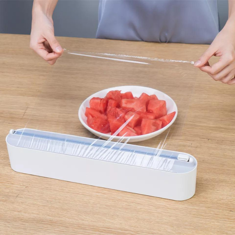 Plastic foil dispenser with sliding cutter