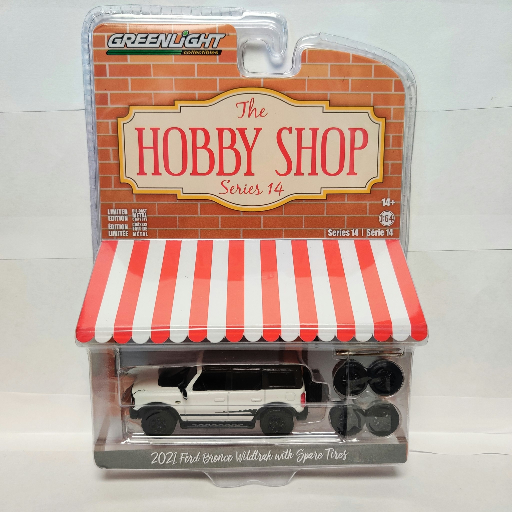 Skala 1/64 Ford Bronco 21' m ext 4x däck & fälg "The hobby shop" fr Greenlight