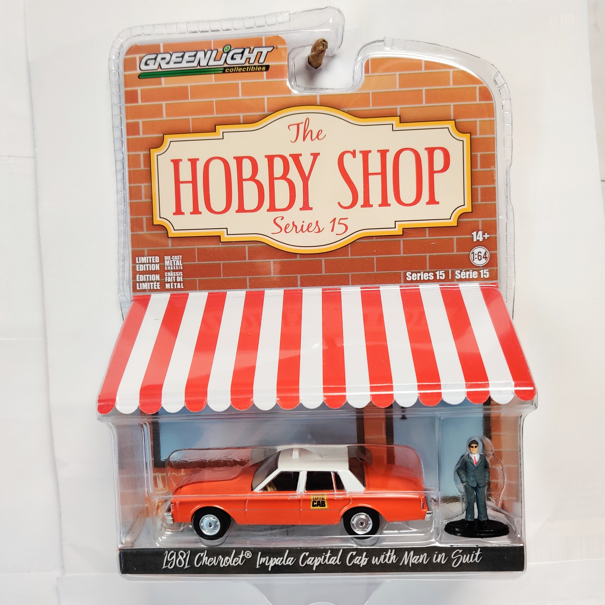 Skala 1/64 Greenlight "The Hobby Shop" 1981 Chevrolet Capital Cab w man in suit