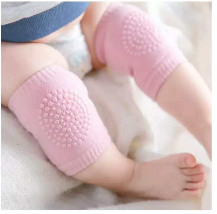 Bebis som har rosa knäskydd på sif