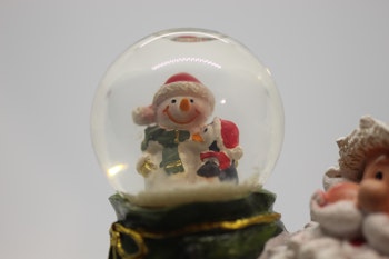 Nisse med snøkule i grønn sekk