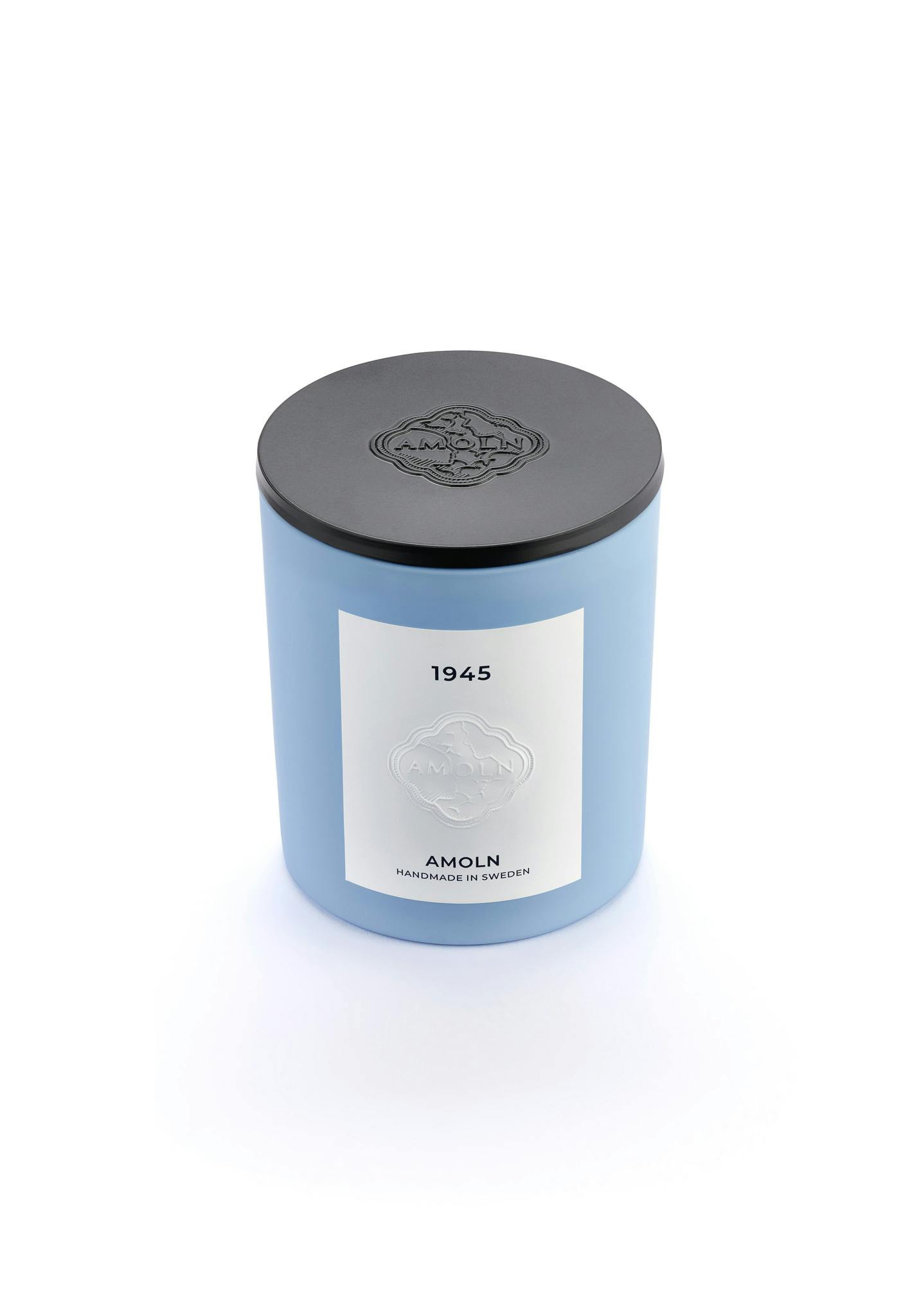 Light blue ceramic candle jar with a vegan, scented candle in blue wax, with black metal lid. Handcrafted by artisans in Sweden. Sustainably & ethically made.
