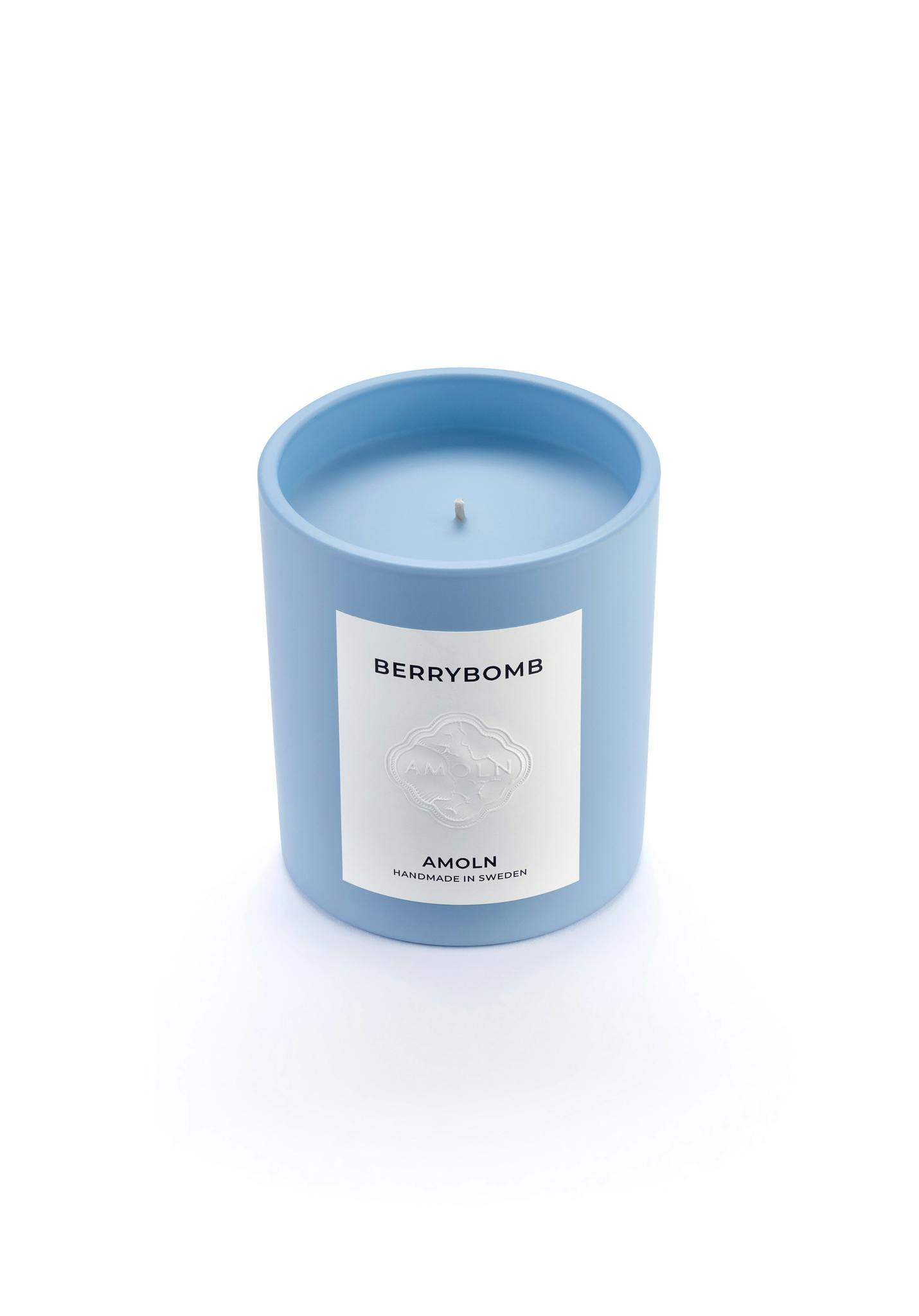 Light blue ceramic candle jar with a vegan, scented candle in blue wax for a luxurious gift. Handcrafted by artisans in Sweden. Sustainably & ethically made.