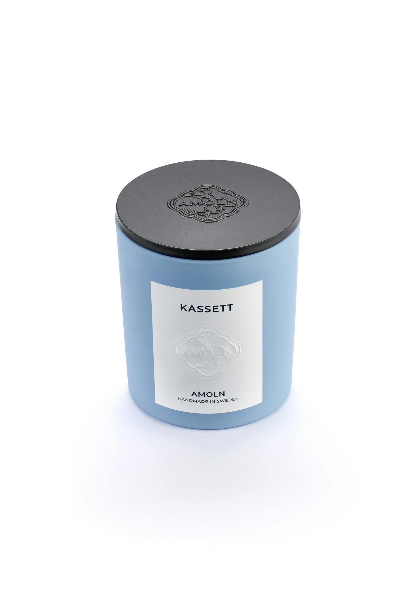 Light blue ceramic candle jar with a vegan, scented candle in blue wax with black metal lid. Handcrafted by artisans in Sweden. Sustainably & ethically made.