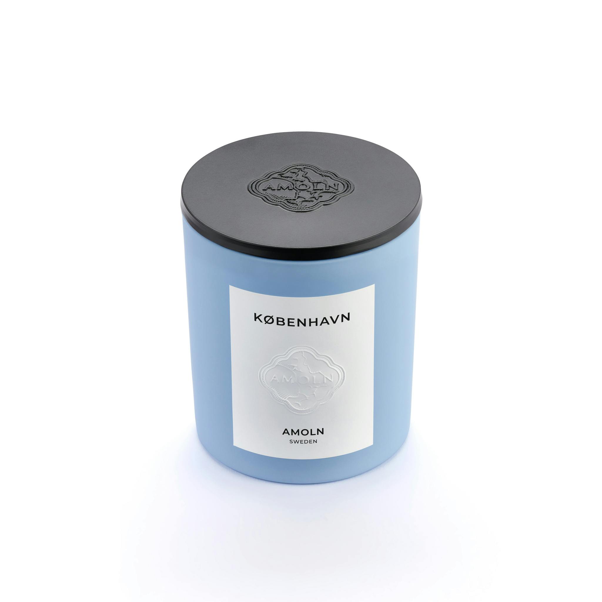 Light blue ceramic candle jar with a vegan, scented candle in blue wax & black metal embossed lid. Handcrafted by artisans in Sweden. Sustainably & ethically made.