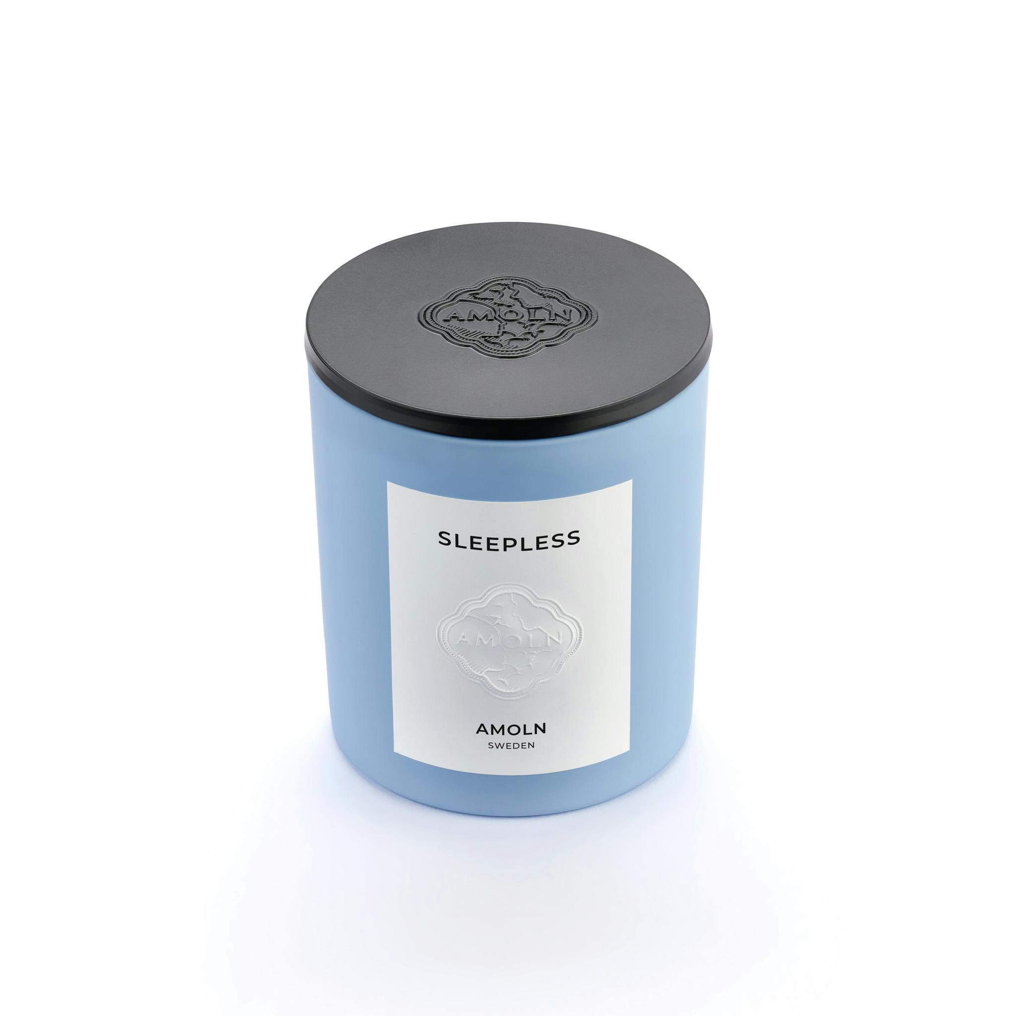 Light blue ceramic candle jar with a vegan, scented candle in blue wax with embossed metal lid. Handcrafted by artisans in Sweden. Sustainably & ethically made.