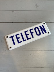Skylt telefon