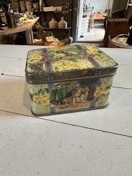 Liten plåtburk med hundar