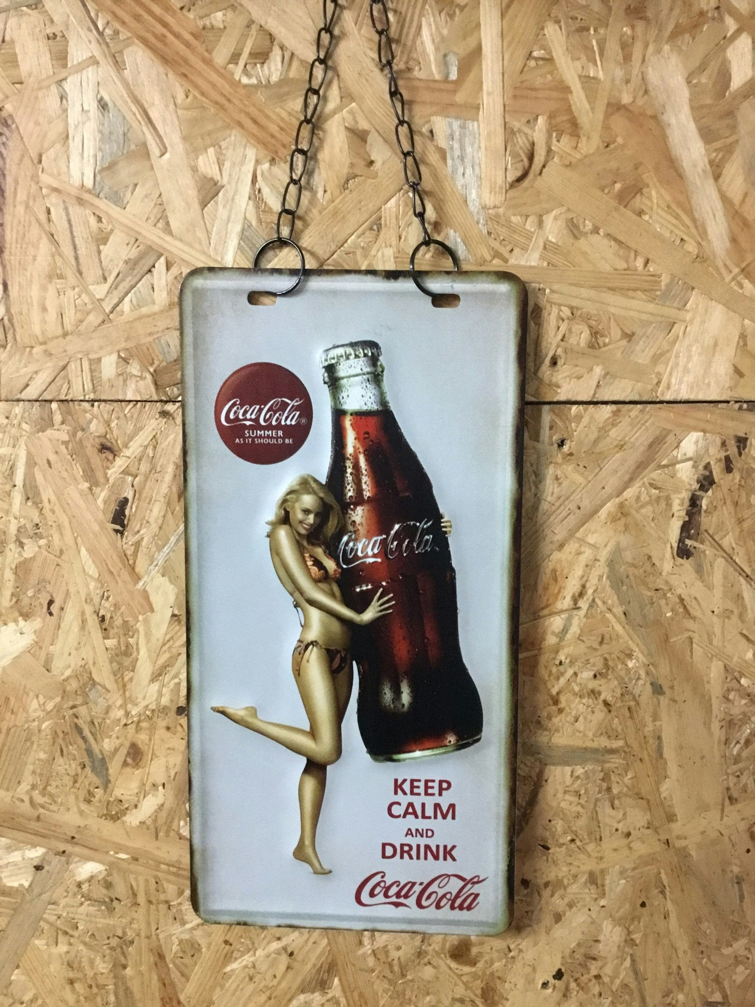 Plåtskylt hängande Coca Cola