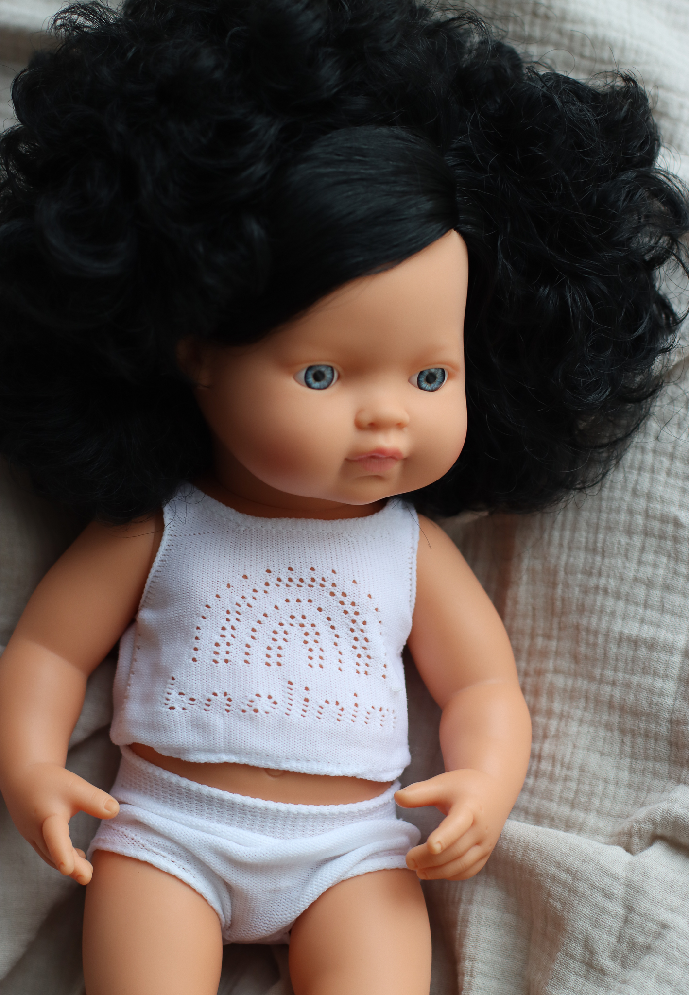 Baby doll caucasian girl with curly hair