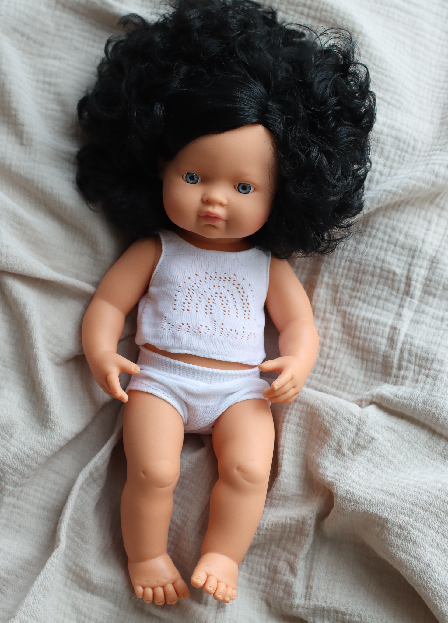 Baby doll caucasian girl with curly hair