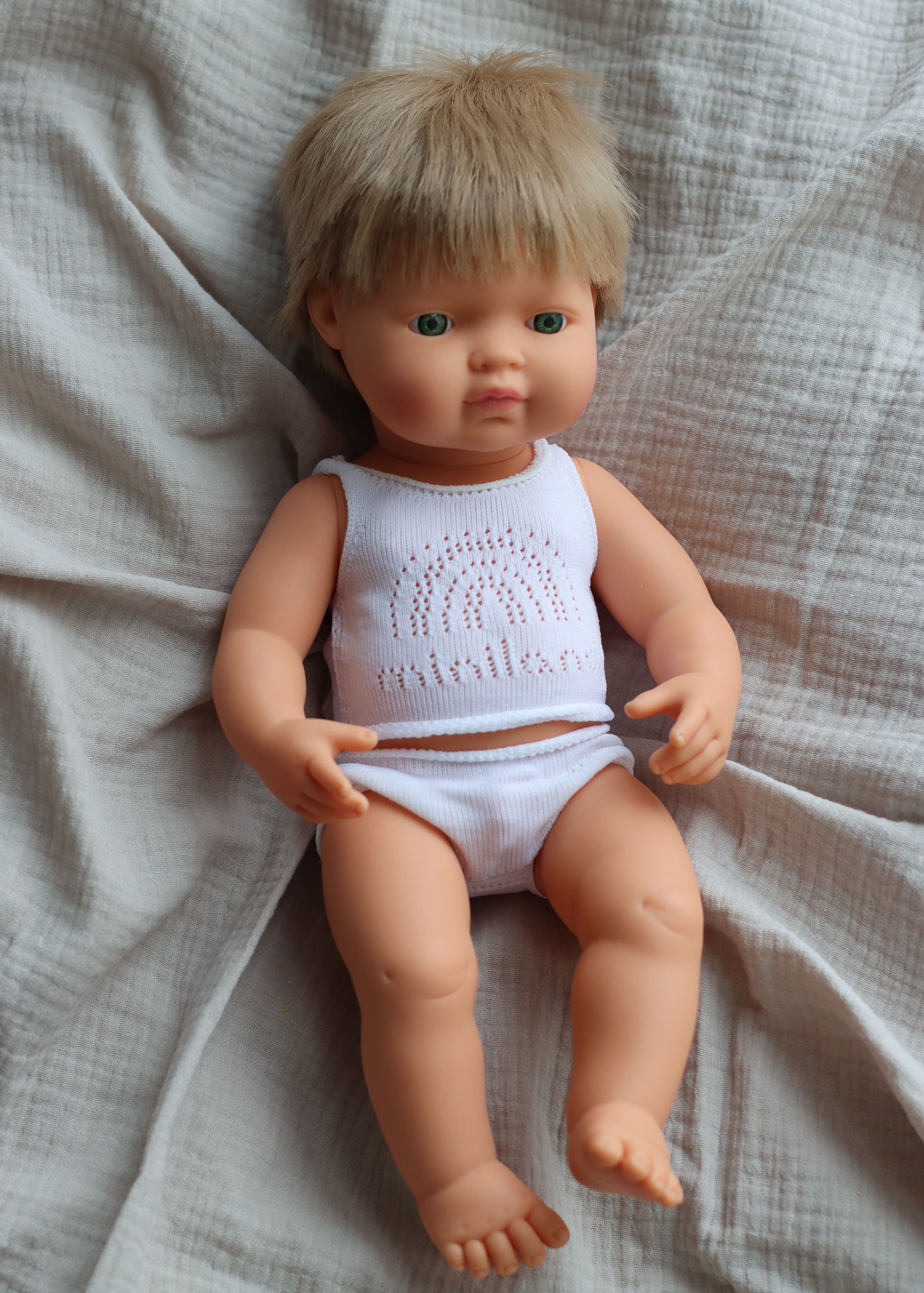 Baby doll caucasian boy with dark blonde hair