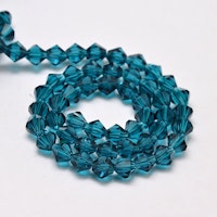 3094 Glaspärlor bicones 6mm på sträng transparent steel blue