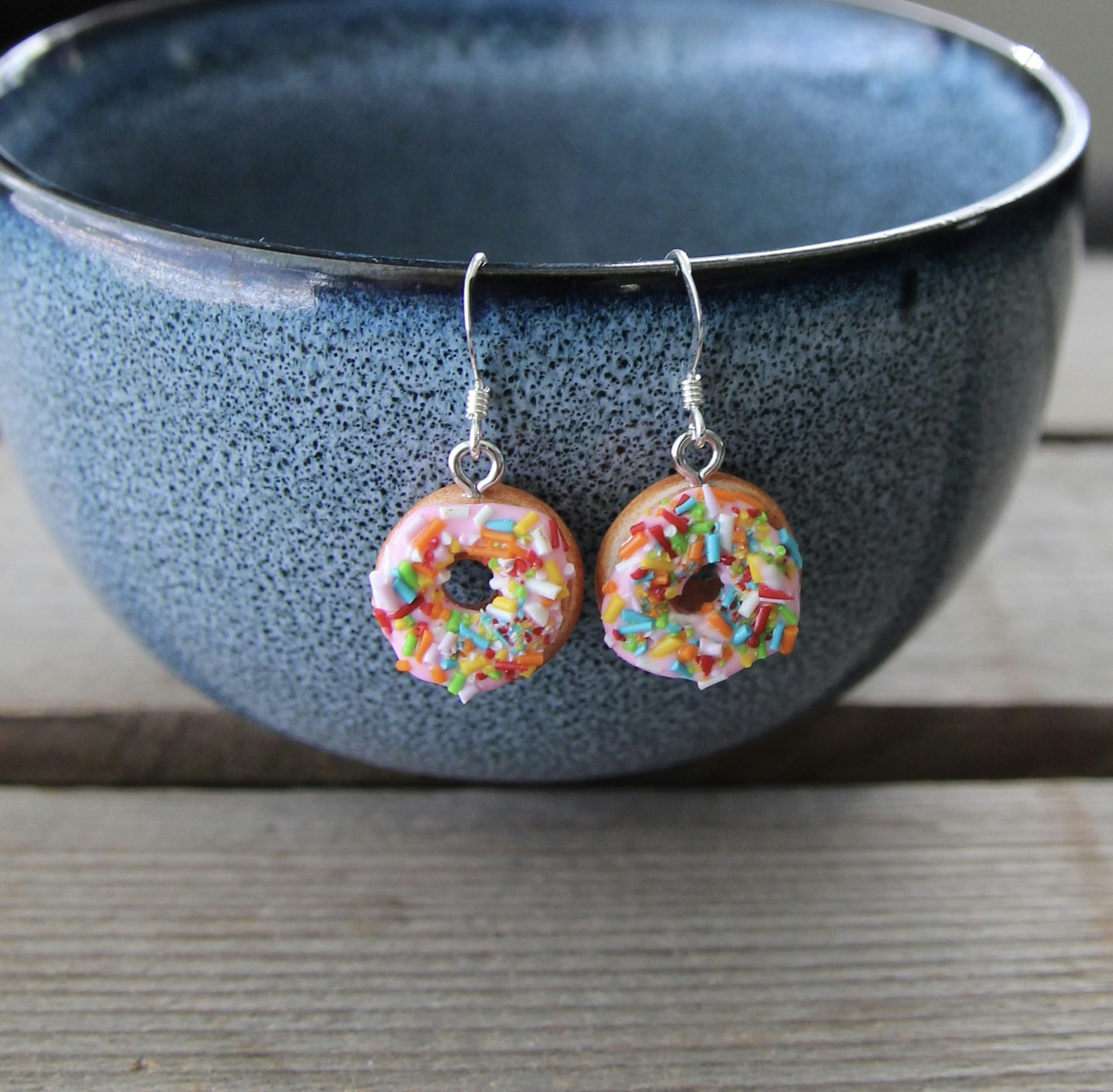 Earrings, donuts with pink icing and sprinkles without a bite