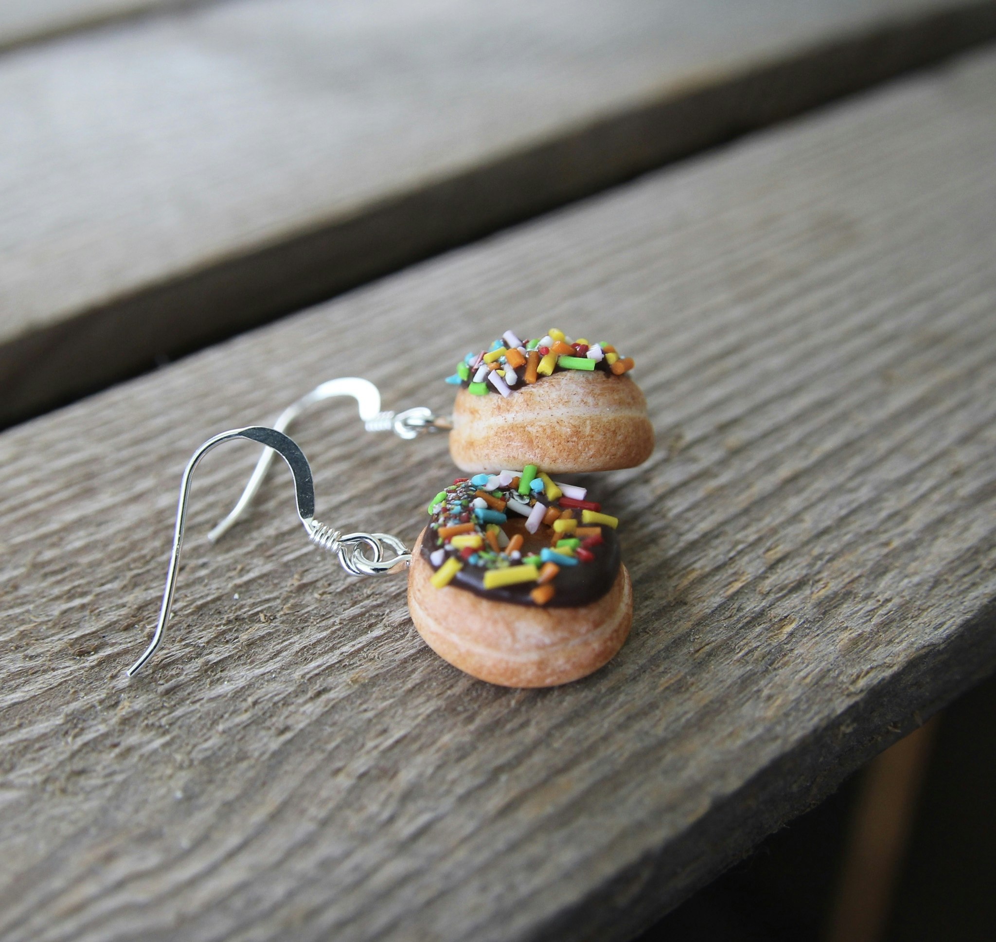 Earrings, donuts with chocolate glaze and caramel sprinkles without a bite
