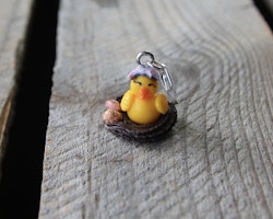 Necklace pendant, chicken in a chocolate bird's nest with small chocolate eggs