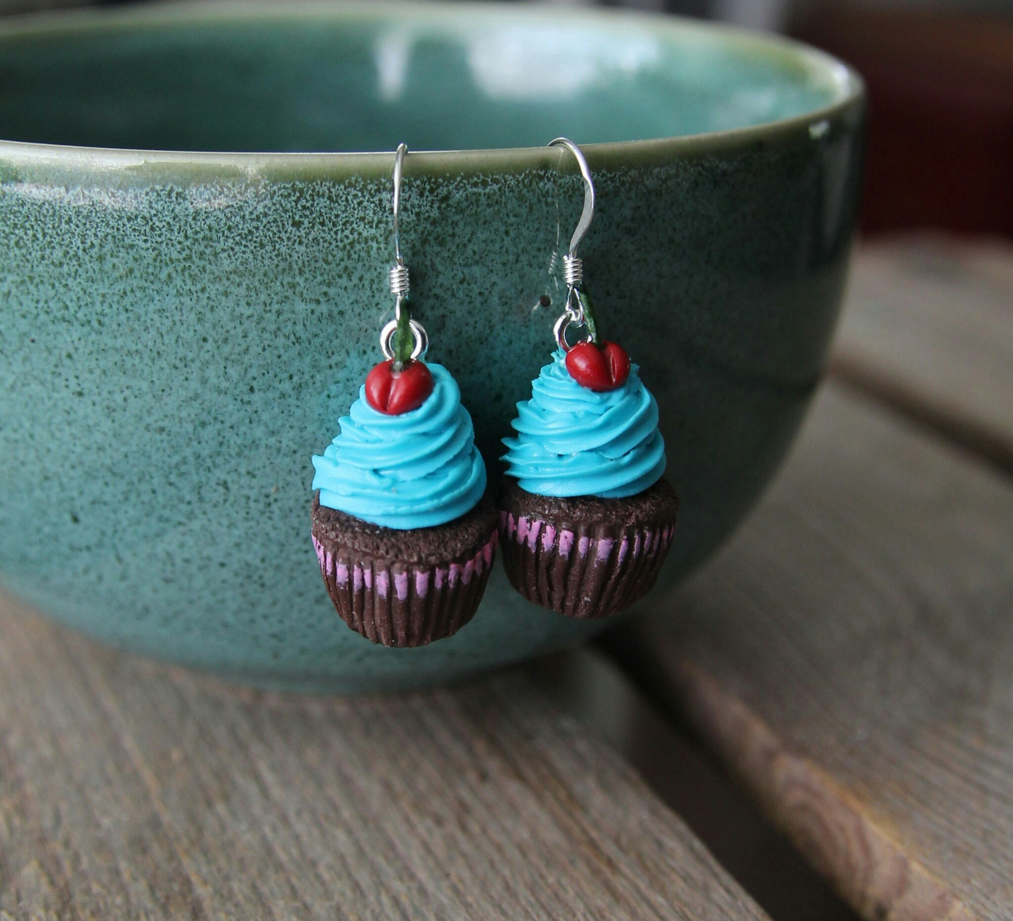 Earrings, chocolate cupcakes with turquoise frosting and cherries.