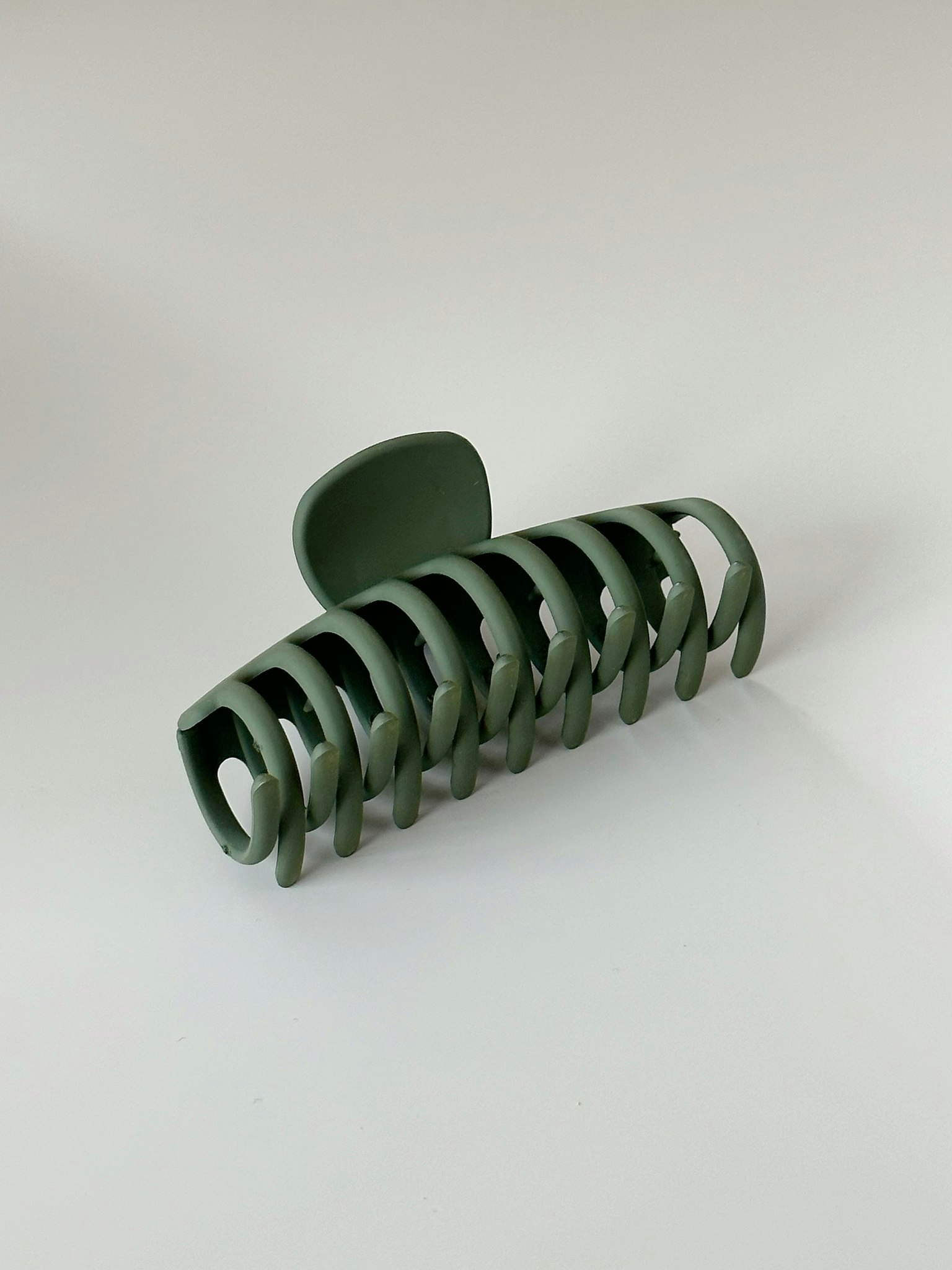 Mörkgrön hårklämma med avlång design