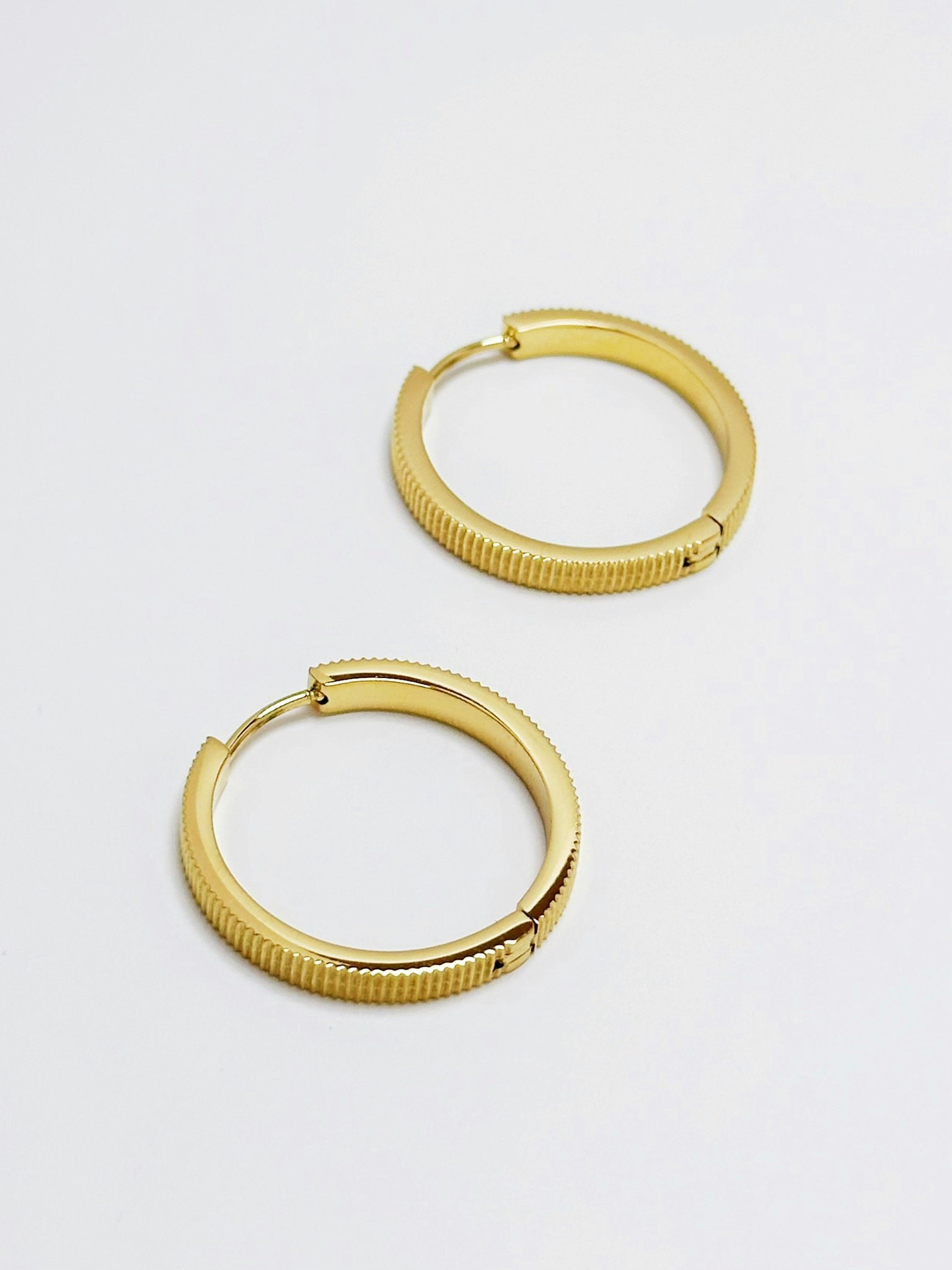 Hoops i stål med 18K guld med räfflat mönster