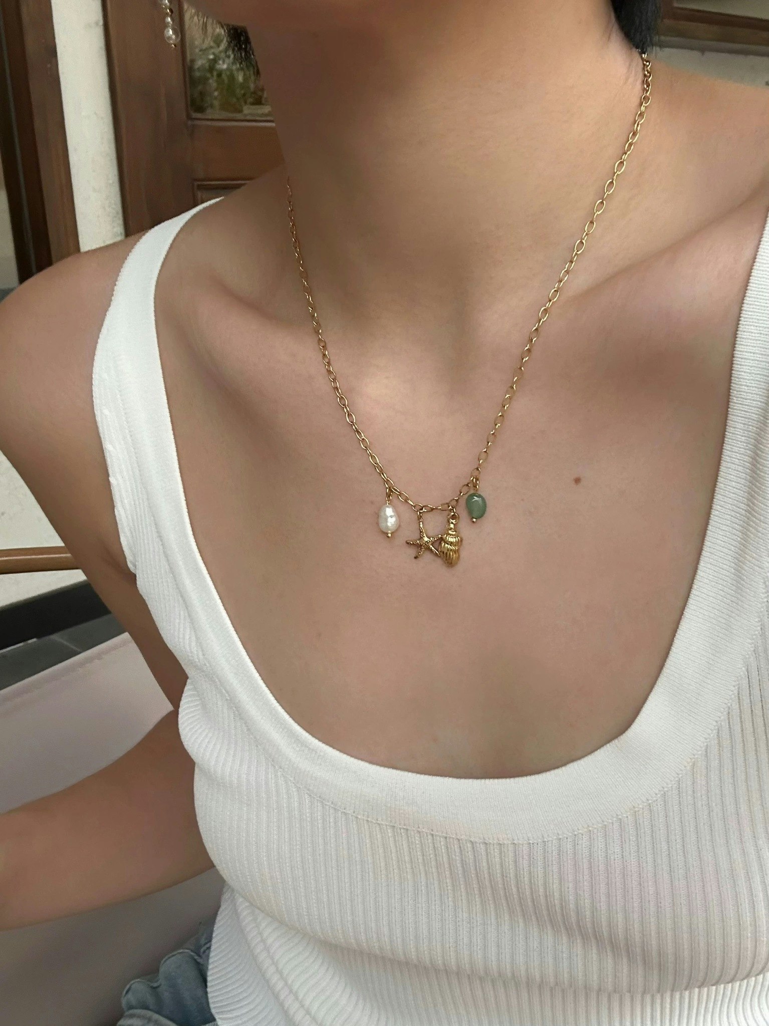 Halsband i stål med 18K guld med sjöstjärna och pärla