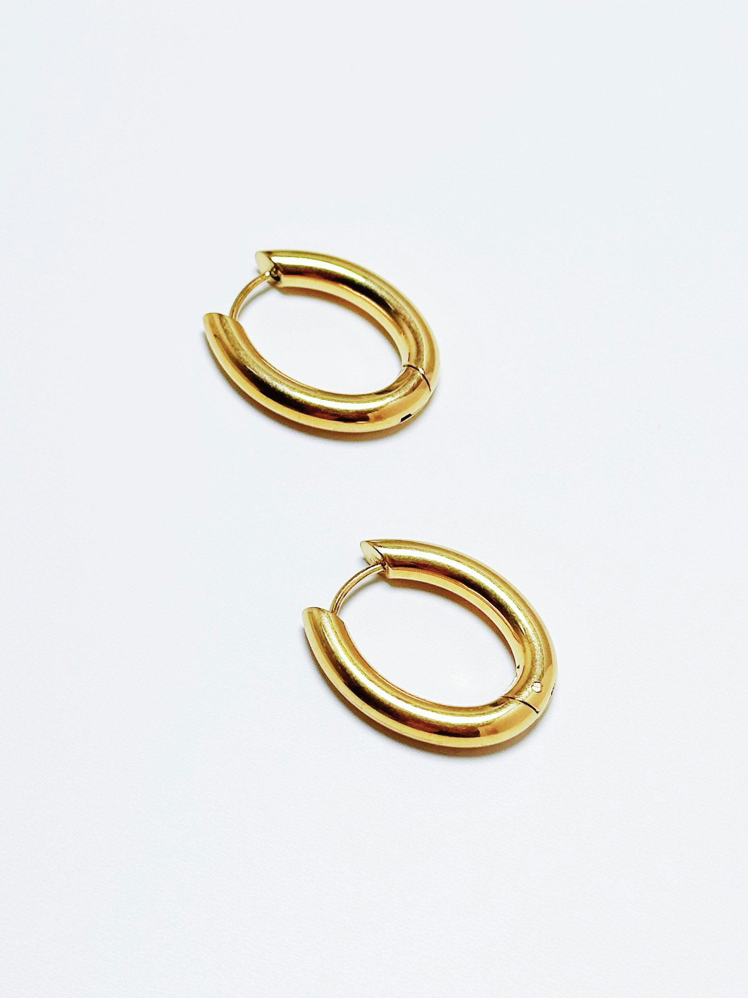 Ovala hoops i stål med 18K guld