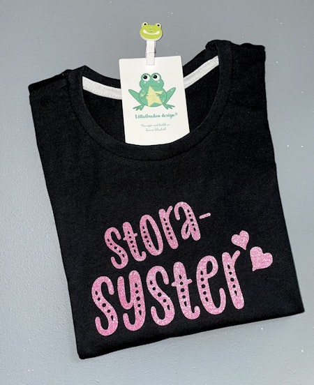 T-shirt Storasyster, svart med Glitter Flamingorosa