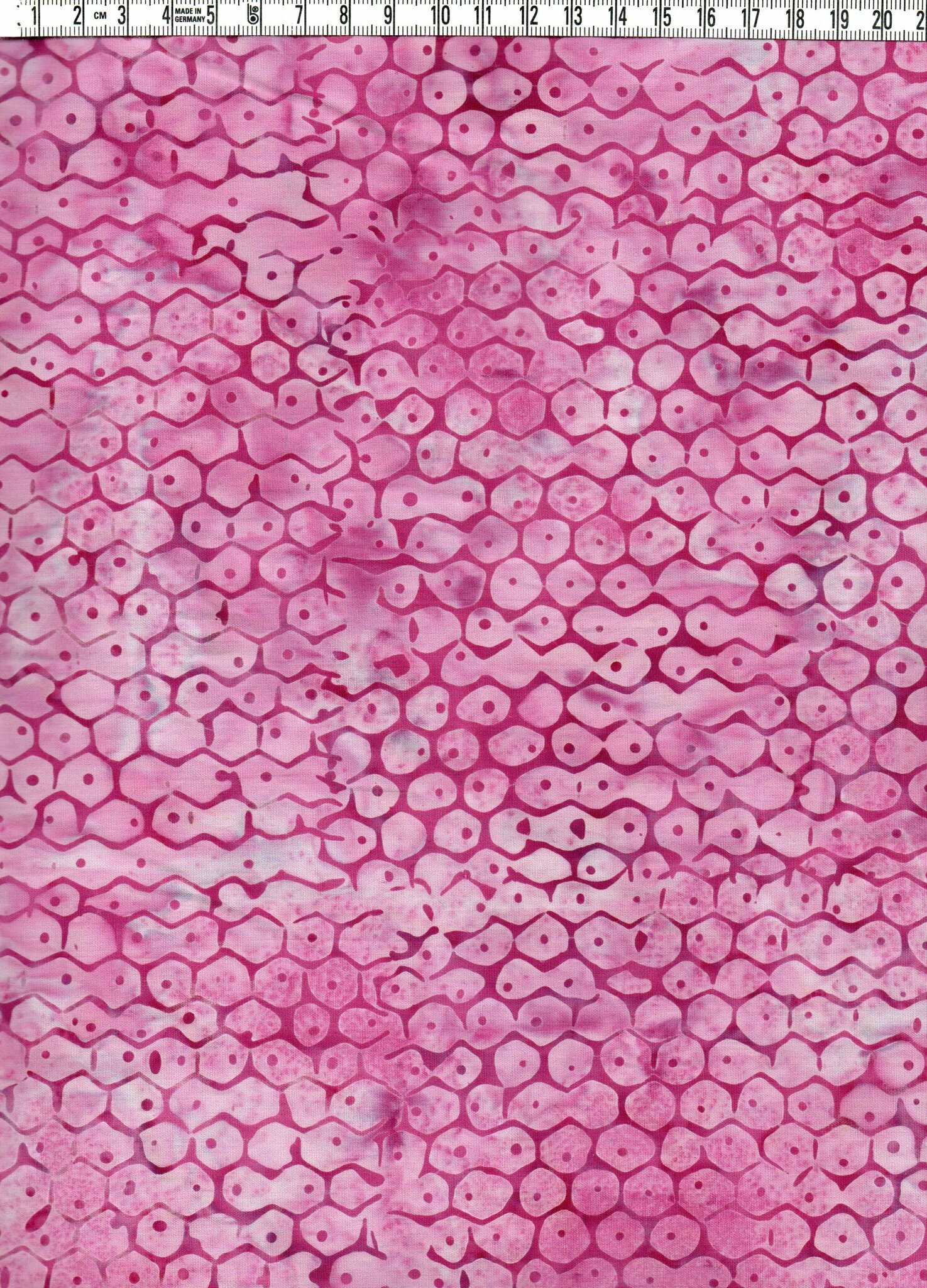 Batiktyg med bikakeinspirerat tryck i rosa toner