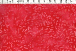 Röd med ljusare "riskorn" . Bomullsbatik bredd 110 cm