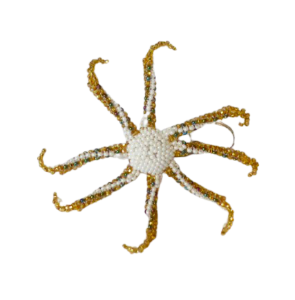 Nyckelring i form av en åttaarmad bläckfisk, octopus, pärlad för hand av små glaspärlor av mayakvinnor i Guatemala. Bild på undersidan.