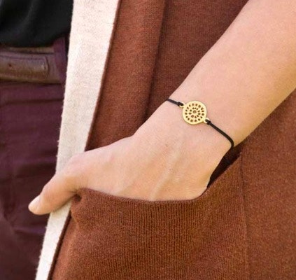 Armband med fint mandala-smycke, 24 karat gulddouble, guldpläterat. Guldet är certifierat Fairmined, Colombia. Armsmycket skapades av konstnärsverkstad i Bogota enligt Fair Trade.  Bild med armband ru